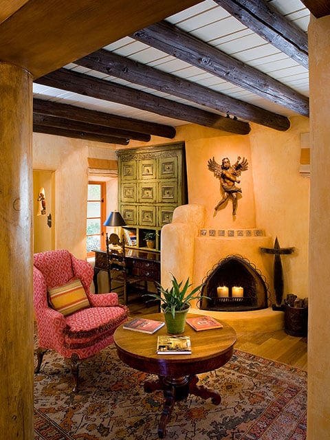 An antique Mexican angel embellishes this simple kiva fireplace