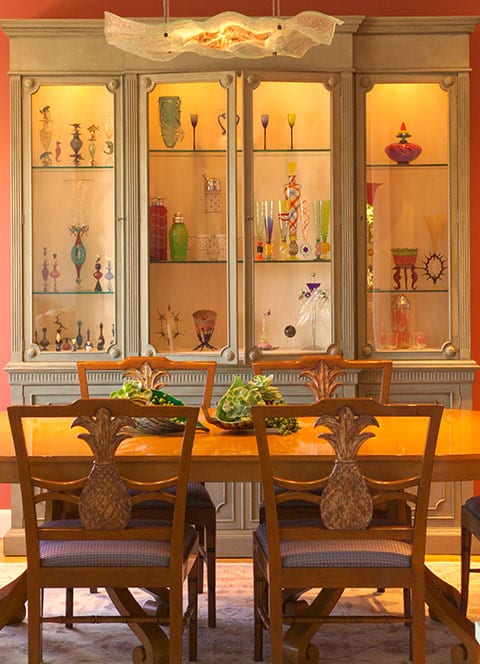 The hand blown glass collection glimmers in the apricot light