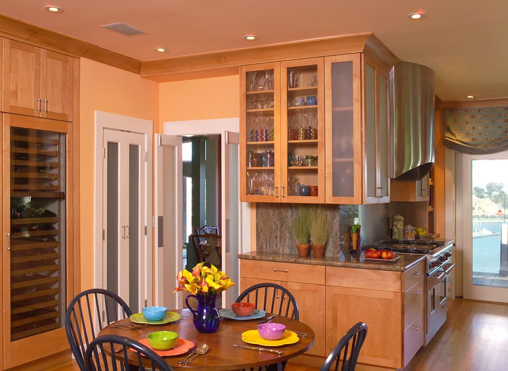 The kitchen's warm maple cabinet and salmon colored walls