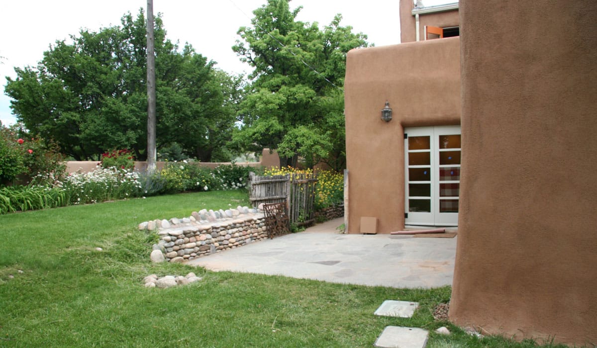 Before: The patio and adjacent garden and low perimeter adobe wall
