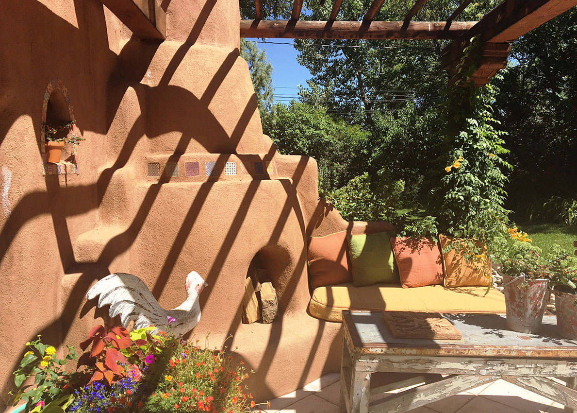 After: A kiva fireplace, arbor and banco separate the patio from the back yard