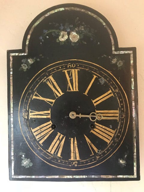 Both hands on the old black wall clock were set to 3:15