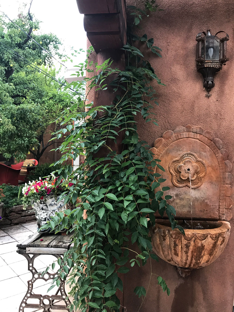 After: A custom-designed wall fountain installed under the new arbor