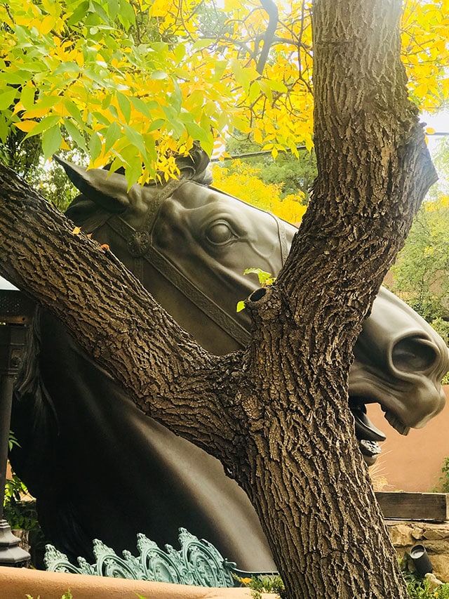 Bronze horse and yellow leaves