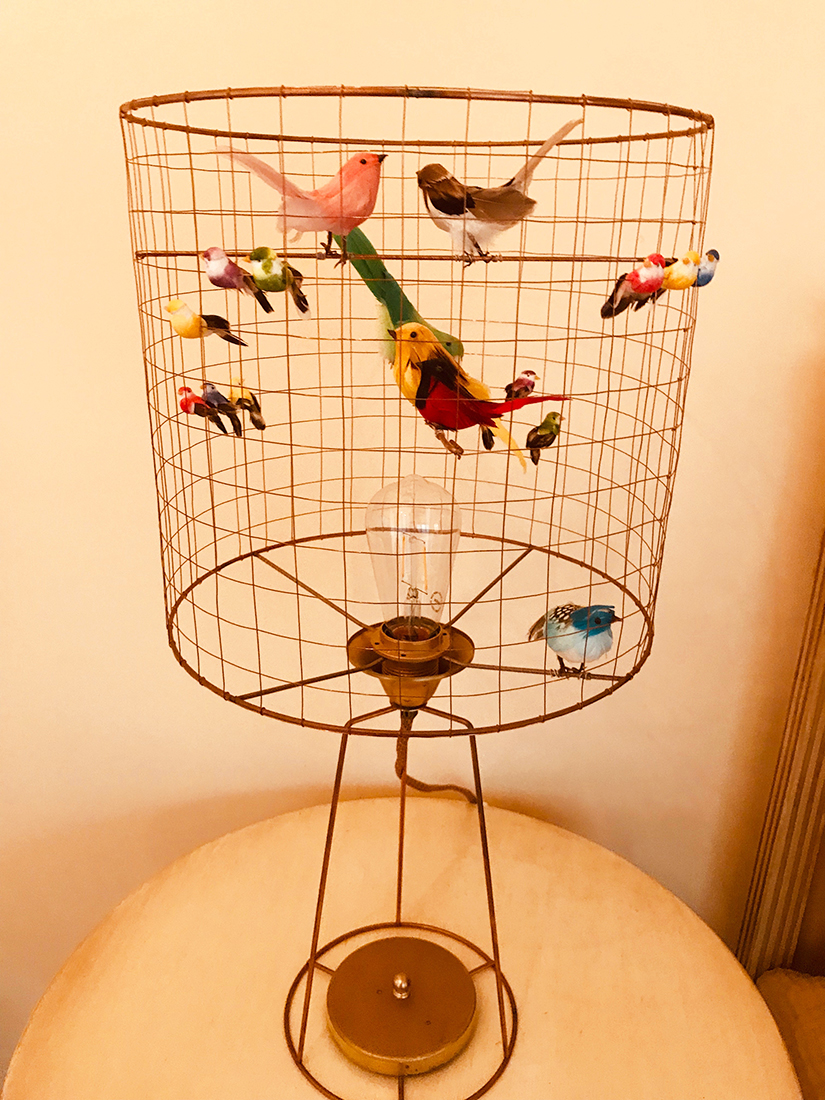 Image with caption "To my eye the unexpected birdcage lamp was a work of art."