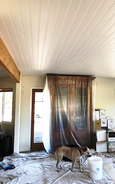 The faux bead board wallpaper added needed character to the ranch house living room ceiling.