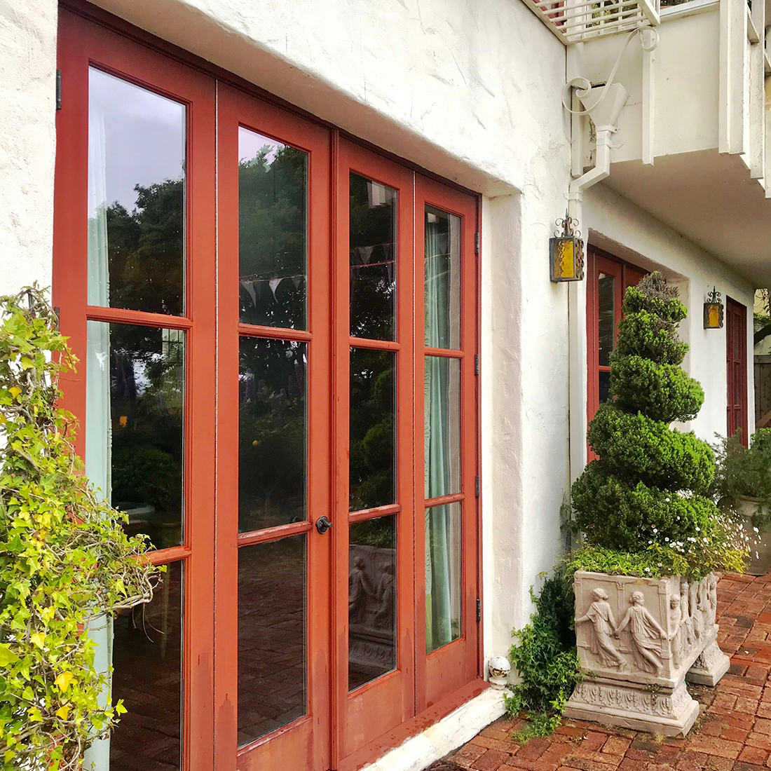 New bi-fold French doors will replace the old terrace doors with failing hardware and foggy glass panes.
