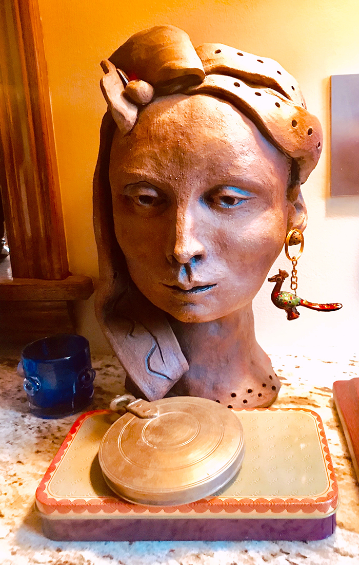 The clay female bust with bird keychain