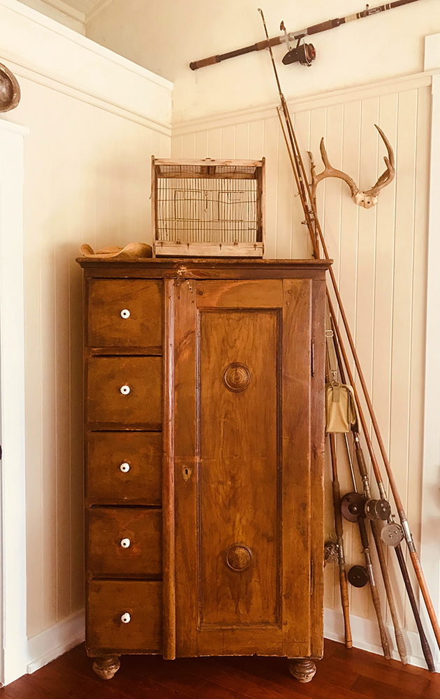 An authentic sturdy cupboard with timeless fishing rods