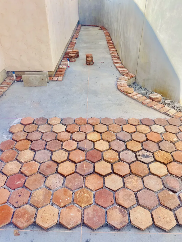 Colorful hexes and bricks installed on front patio